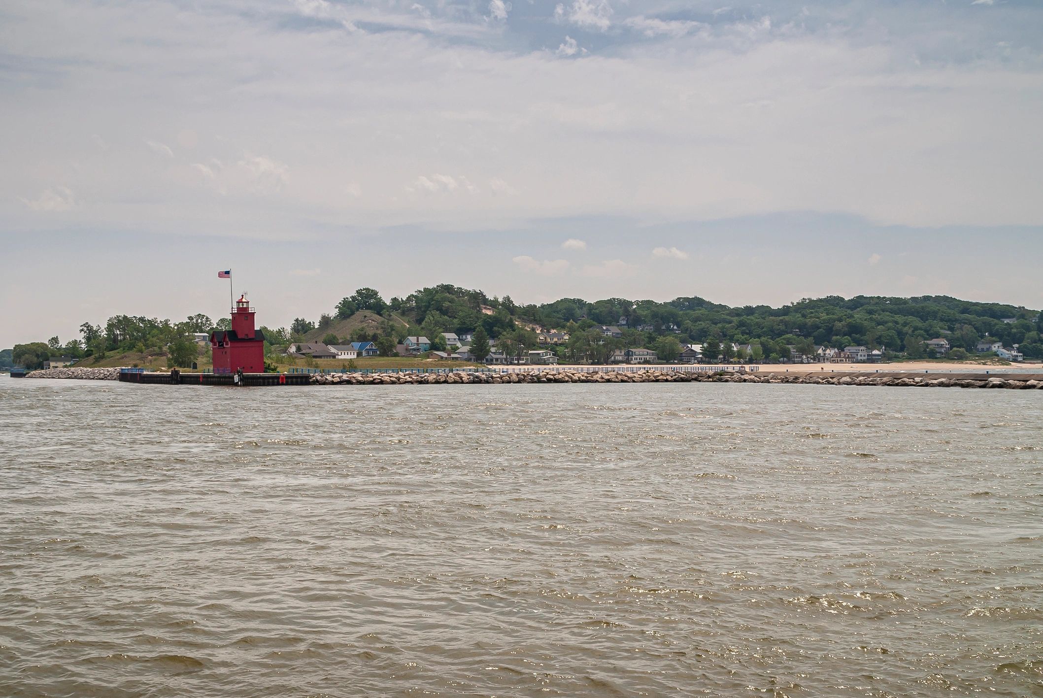 Wide shot of harbor lighthouse and lake, Holland, MI, USA.