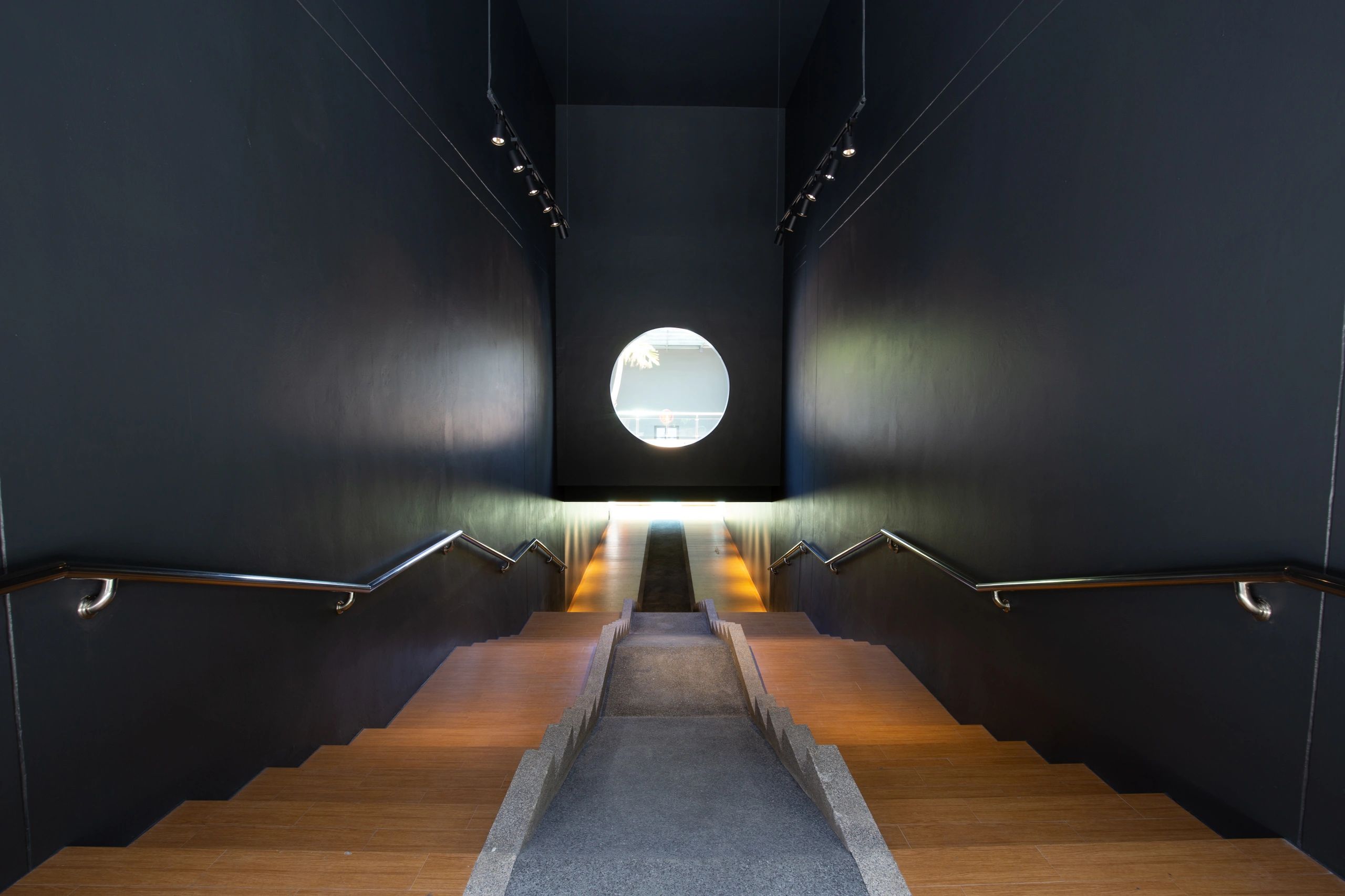 Dark modern corridor representing secure circulation within a luxury bunker