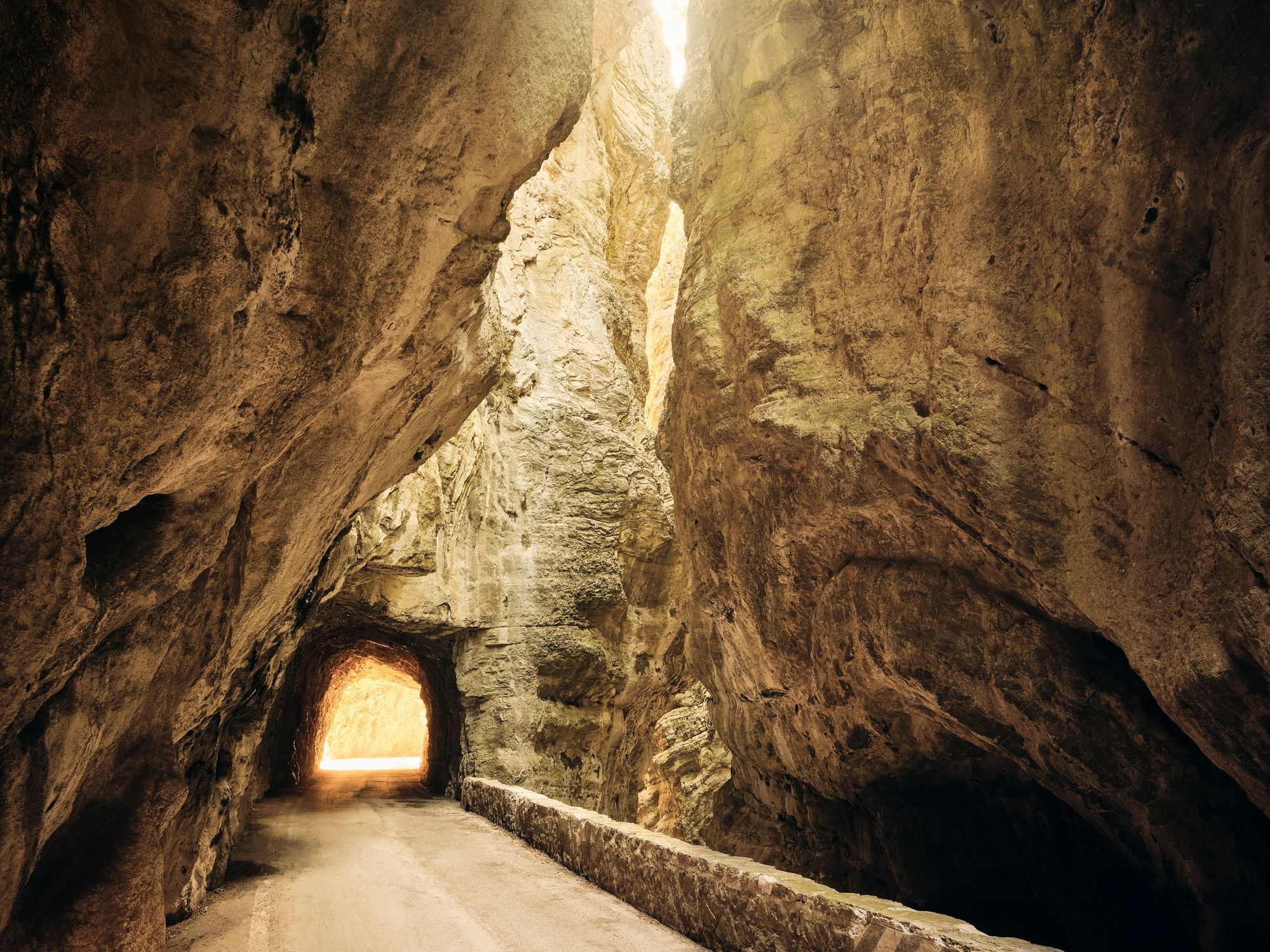 Mountain road through dramatic rock landscape representing Vermont terrain and remote site planning