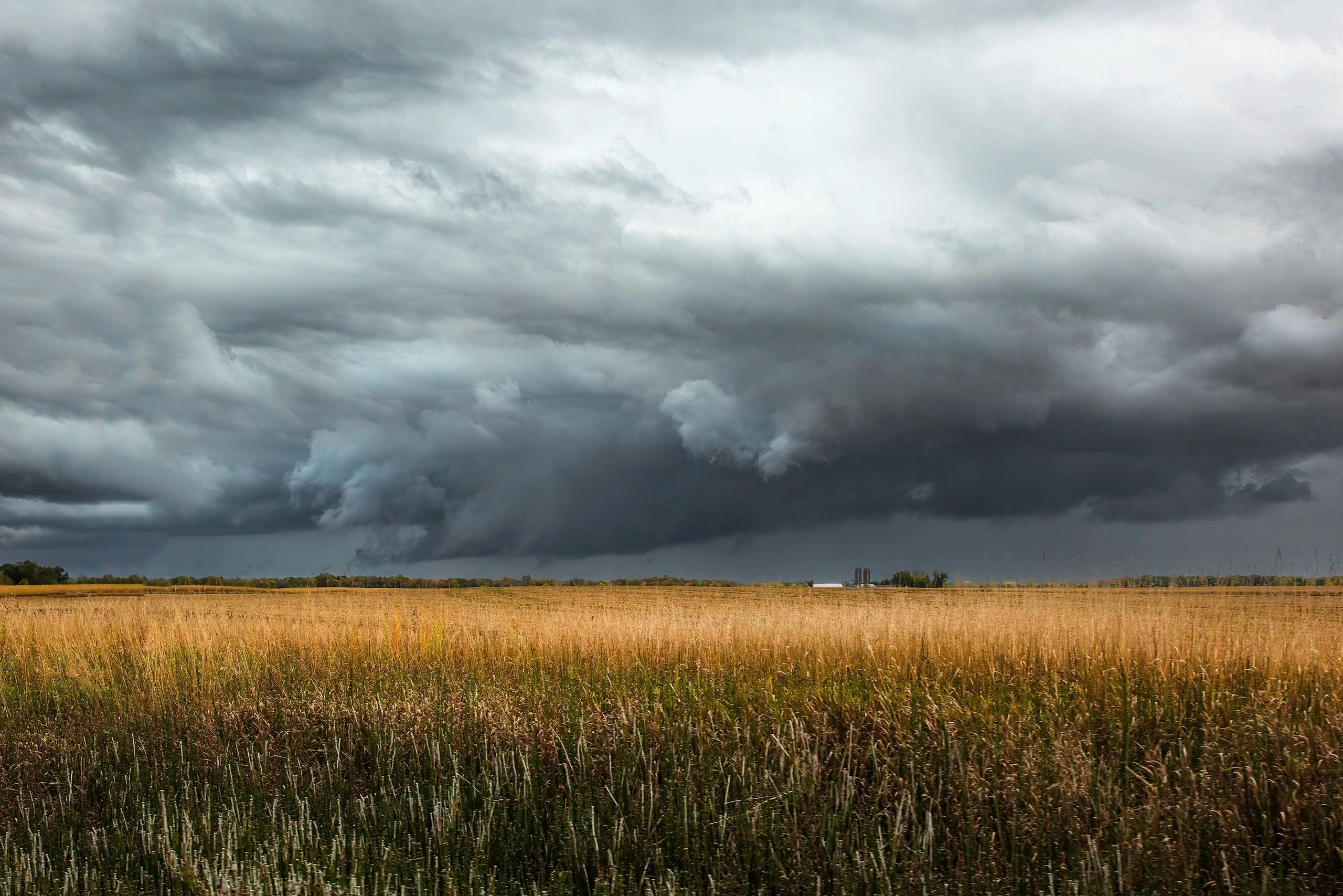 Iowa rural landscape with open fields and dramatic clouds