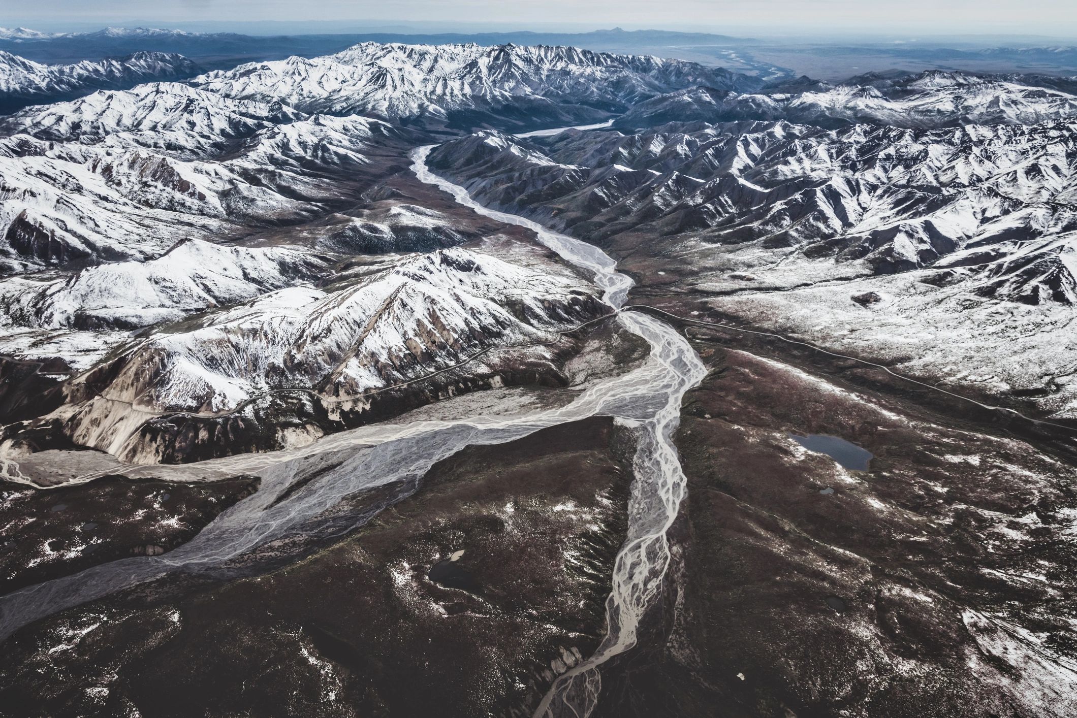 Aerial Alaska mountain landscape representing remote site selection and resilient bunker planning