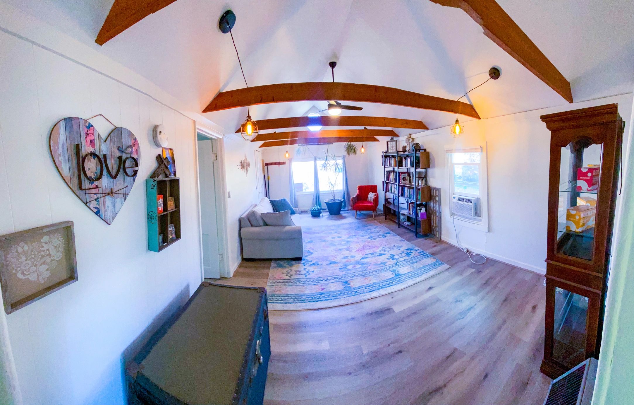 Wide furnished living room with exposed beams