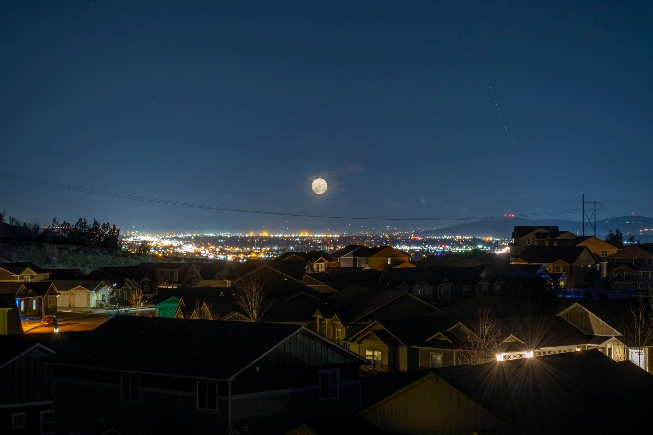 Residential neighborhood at night illustrating local vulnerability during outages